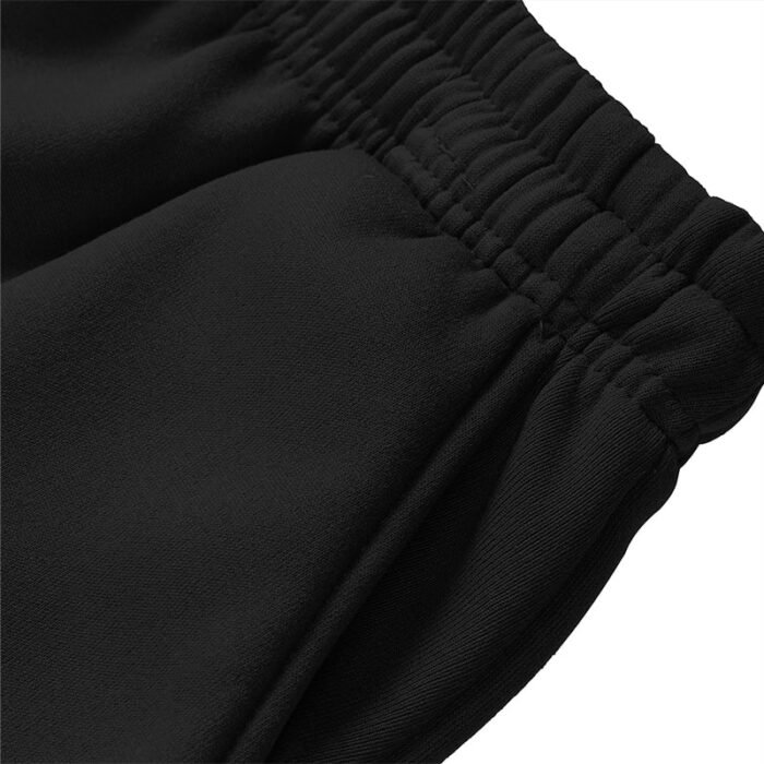 Close-up of black sweatpants/joggers elastic waistband with internal drawstring and side pocket entry