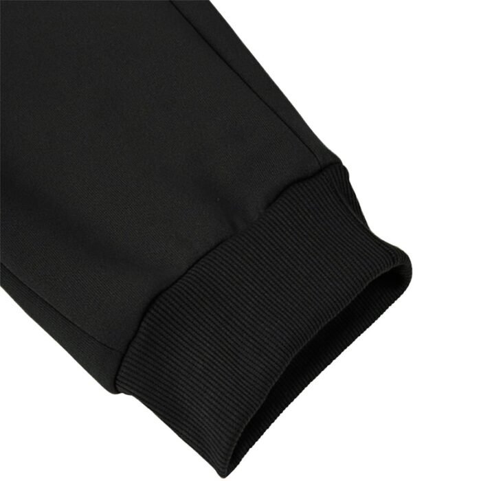 Close-up of black athletic sweatpants/joggers ribbed ankle cuff, showing strong elastic and neat stitching
