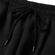 Close-up of 250G black jogger pants elastic waistband with black adjustable drawstring and metal tips