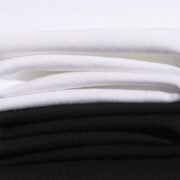 Stacked White and Black T-shirt Fabric - Close-up of Soft, Breathable Material