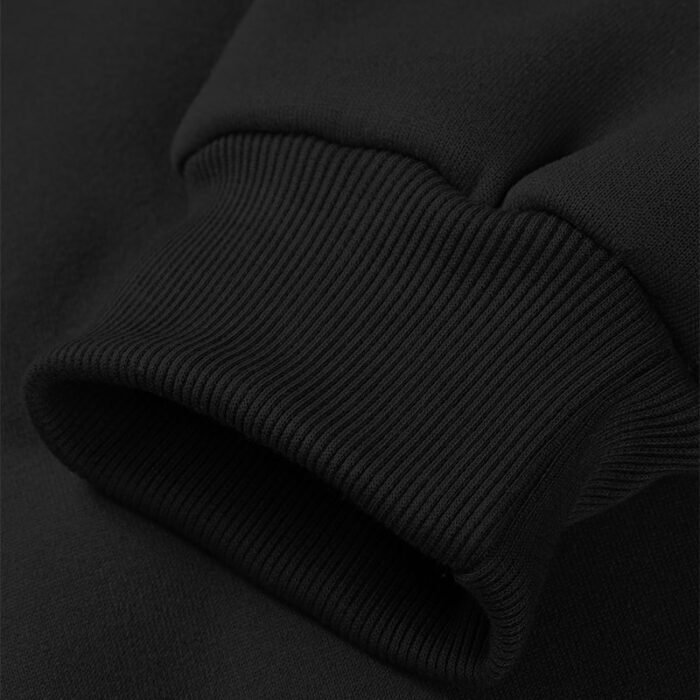 Close-up of the ribbed crewneck collar of a black sweatshirt, part of a Crewneck Sweatshirt Set.