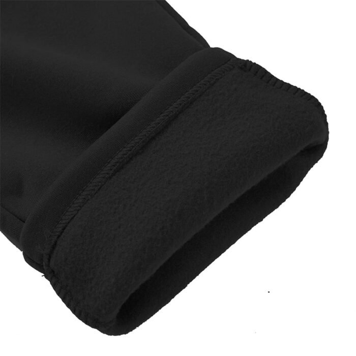 Close-up of black straight-leg pants hem showing soft, brushed fleece lining inside.