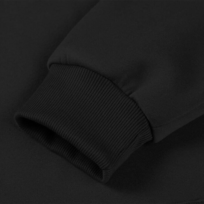 Close-up of the ribbed cuff on the sleeve of a black hooded sweatshirt, showing the texture of the ribbing.