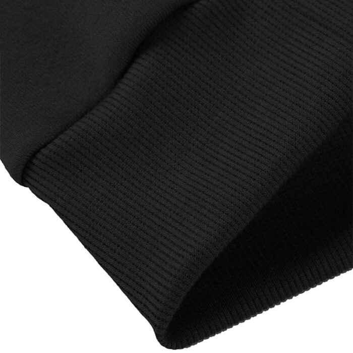 Close-up of the plush, brushed fleece lining inside a black crewneck sweatshirt, part of a Crewneck Sweatshirt Set.