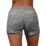 Close-up of the elastic waistband and adjustable drawstring on light grey women's shorts.