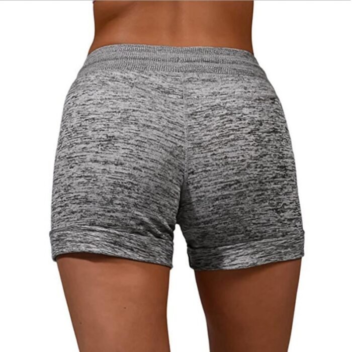 Close-up of the elastic waistband and adjustable drawstring on light grey women's shorts.